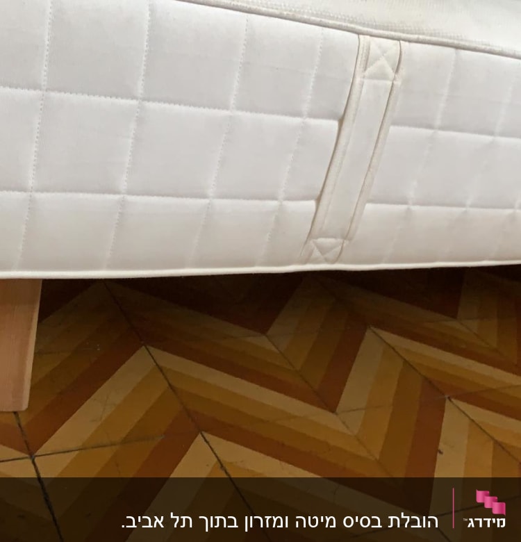 מזרן עם ידית נשיאה על רצפה מעץ